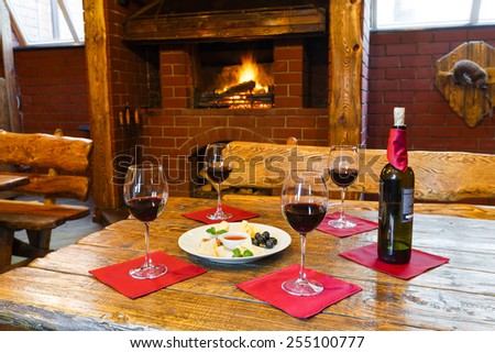 Romantic dinner for two near fireplace - wine and cheese plate