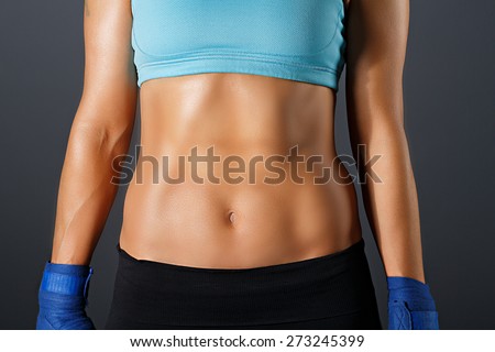 Slim sportive woman torso with strong abdominal  muscles