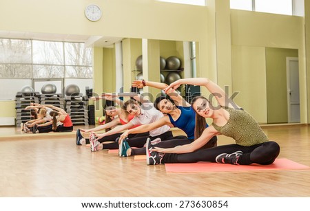Group of women making step aerobics in the fitness class