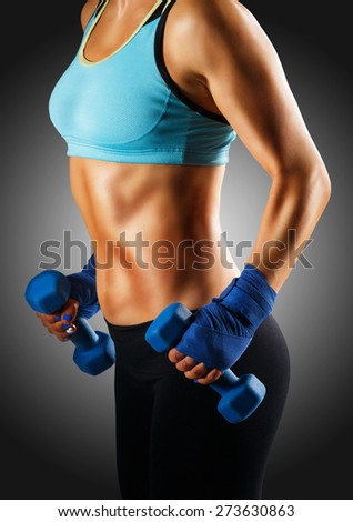 Ideal sportive torso of young woman with bronzed skin and strong abs muscles isolated