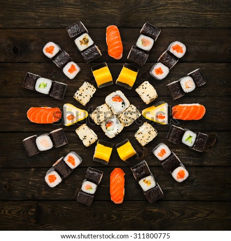 Japanese food restaurant delivery - sushi maki california roll platter set isolated at wooden background, above view