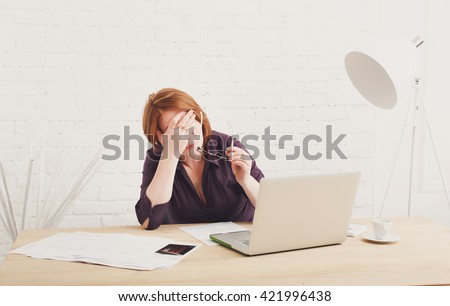 Depressed and upset businesswoman in her office. Middle aged woman sad, frustrated
