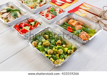 Healthy food delivery. Take away of natural organic low carb diet. Eat right concept, healthy food, clean food take away in aluminium boxes and bag, vegetables and salmon closeup
