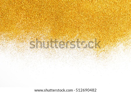 Golden glitter sand texture spread on white, abstract background with copy space. Yellow dusty shimmer decoration border, shiny and sparkling. Holidays and glamour concept.