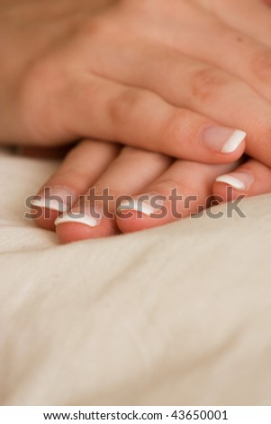 Pair of hands with french manicure on white background