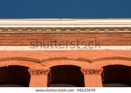 Red brick arches with blue sky