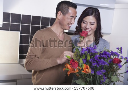 Mature Couple with Bouquet of Flowers, Man Holding a Rose