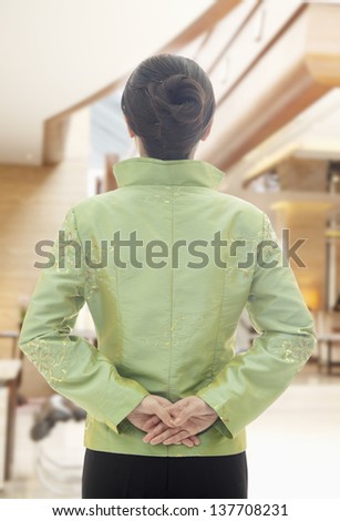 Restaurant/Hotel Hostess in Traditional Chinese Clothing, View From Behind