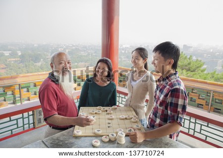 Chinese Family Playing Chinese Chess (Xiang Qi)