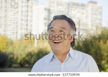 Senior man looking at the sky, portrait