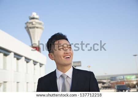 Traveler looking at sky at airport