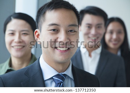 Businessman with co-workers in office portrait