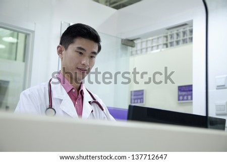 Male veterinarian looking at computer screen