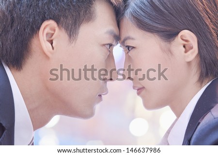 Two Business People Standing Face to Face