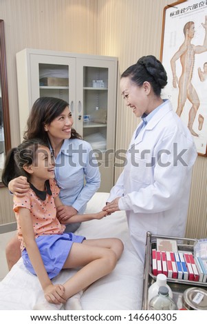 Doctor Talking with Mother and Daughter