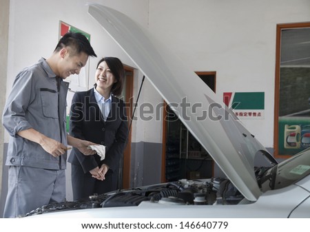 Mechanic Chatting and Laughing with Customer