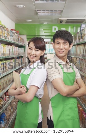 Two Sales Clerks Standing in a Supermarket