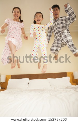 Family Jumping on Bed Together