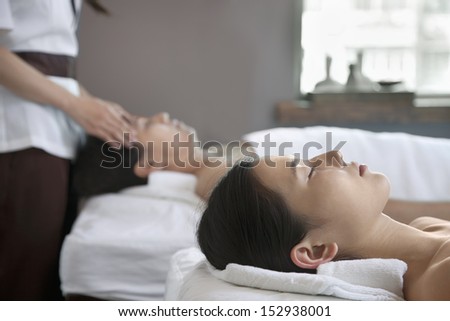 Mother and Daughter Having Head Massage Together