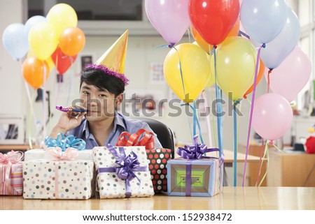 Businessman Blowing a Party Horn