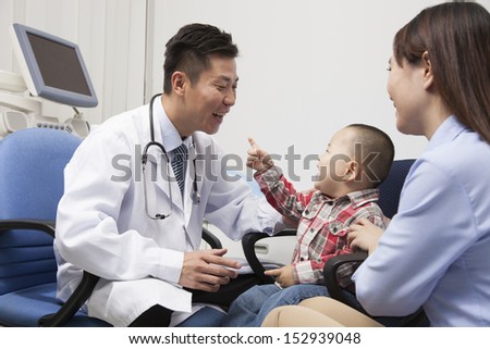 Baby Boy Playing With Doctor In Office