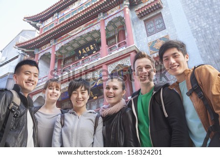 Group of young people with Chinese architecture in background