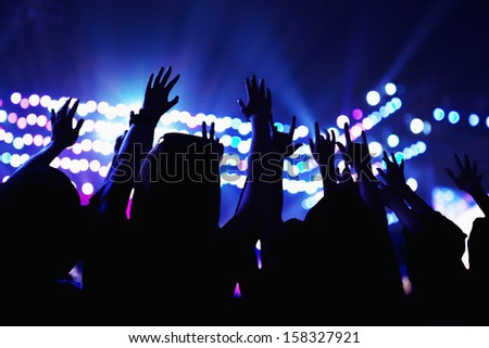 Audience watching a rock show with hands in the air