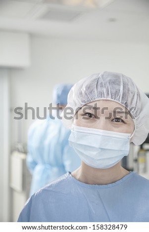 Portrait of surgeon with surgical mask and surgical cap in operating room