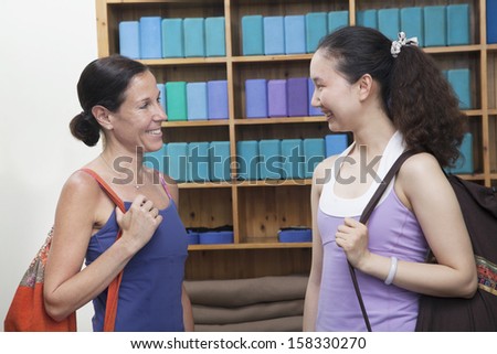 Two friends meeting at the yoga studio