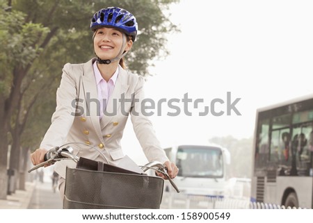 Young business woman commuting with bicycle in Beijing