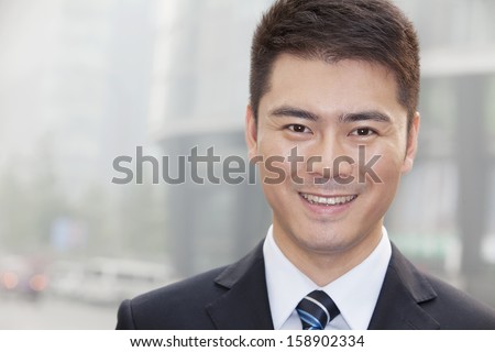 Young businessman smiling and looking into camera