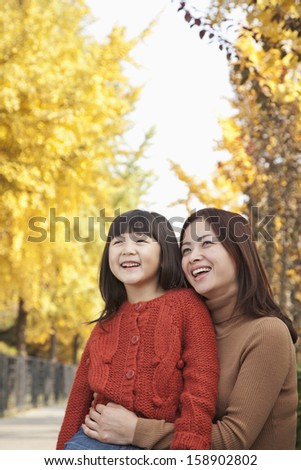 Portrait of mother and daughter in autumn