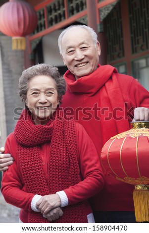 Senior couple holding Chinese lantern