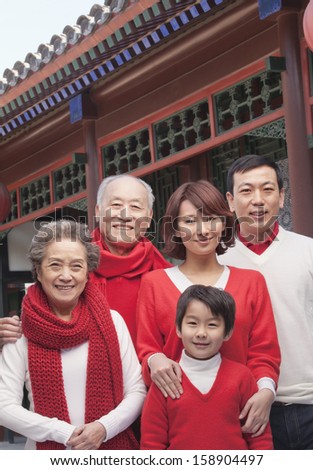 Multi-generation family portrait by traditional Chinese building