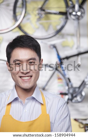 Portrait of young male mechanic in bicycle store