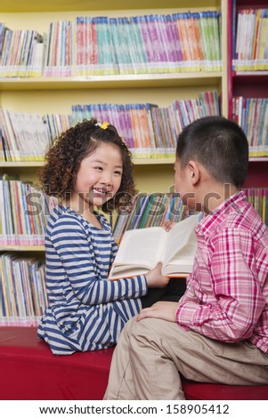 Boy and girl reading together