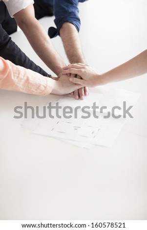 Close up of hands of business people on top of each other in partnership