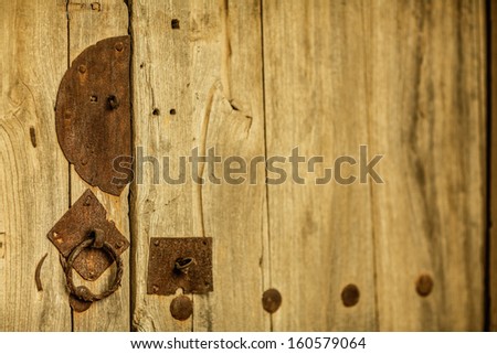 Close up of metal lock and handle on wooden door
