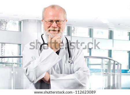 Portrait of pensive senior medical doctor isolated over clinic background