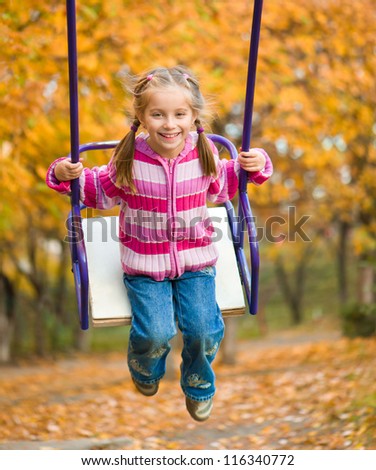stock-photo-little-cute-girl-swinging-at-the-park-in-autumn-116340772.jpg