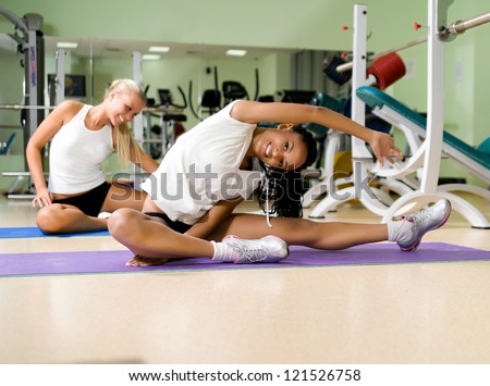 Young pretty woman doing exercises at the fitness club