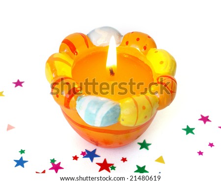 Easter candle and colorful confetti on white background