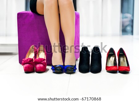 The woman in shop chooses shoes