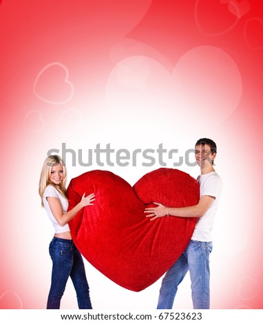 Young couple with a big heart on white background