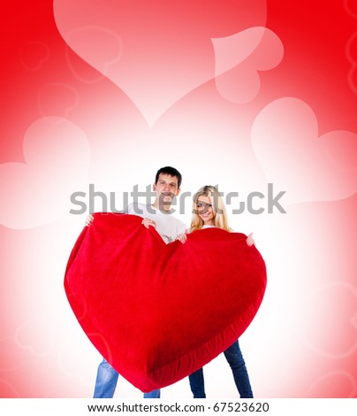 Young couple with a big heart on white background