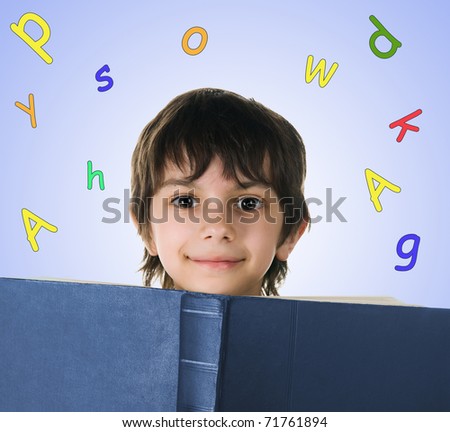 Cute little boy with a big book on white background