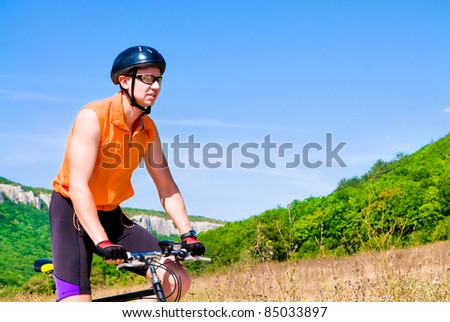 Young sportive man with his black muontain-bike