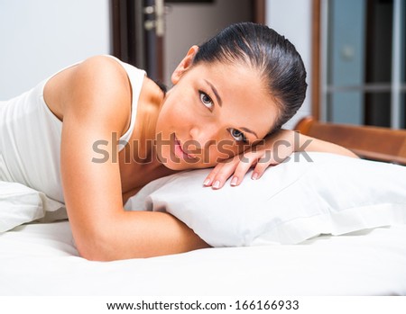 young beautiful girl woke up at home in white bed
