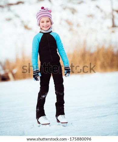 smiling  cute little girl in thermal suits skating  outdoors