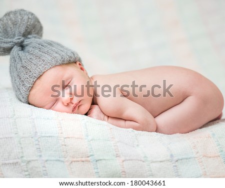 newborn baby girl sleeping in knitted cap
